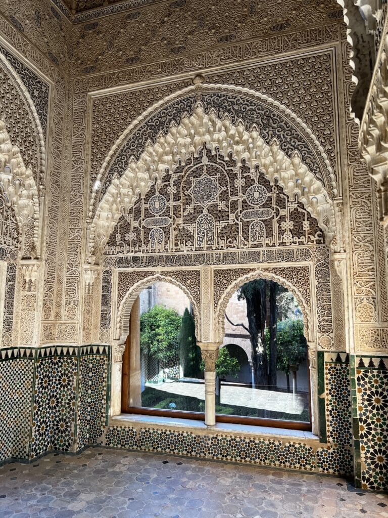A decorative window looking into a garden.