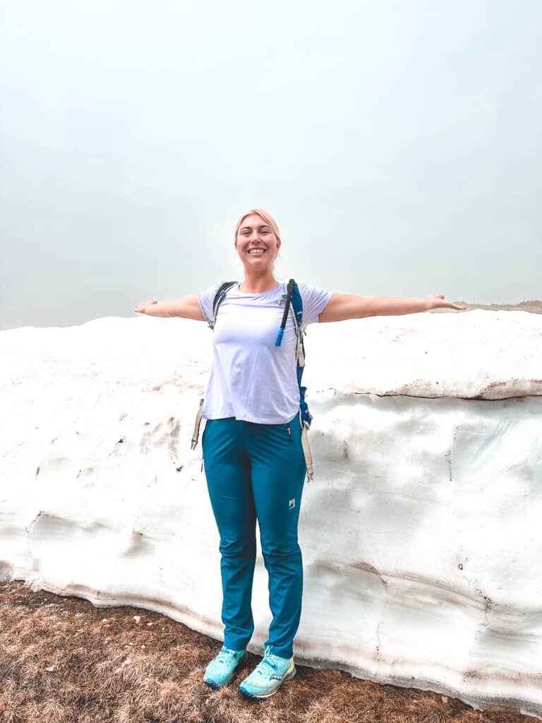 Standing in front of a snow bank in June