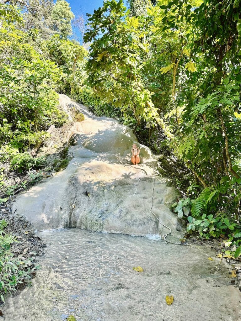 A happy little human bean at the Sticky Waterfalls