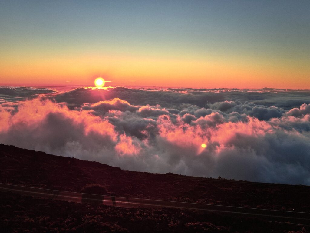 The sun sinking below the clouds on Haleakala, Maui