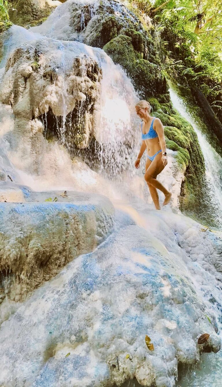 Walking under the falling water at the Sticky Waterfalls