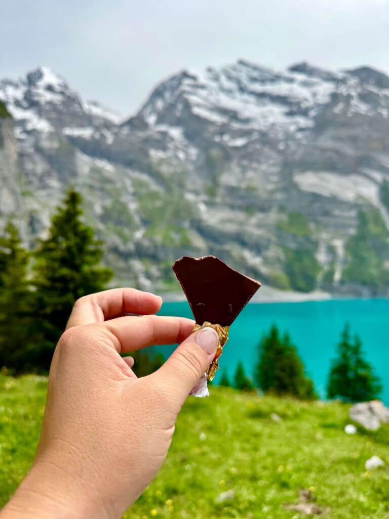 A person enjoying swiss chocolate at Oeschinensee