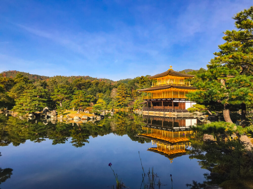 Kinkaku-ji Shrine, Golden Pavilion, surrounded by autumn foliage and across a reflecting pond in Kyoto