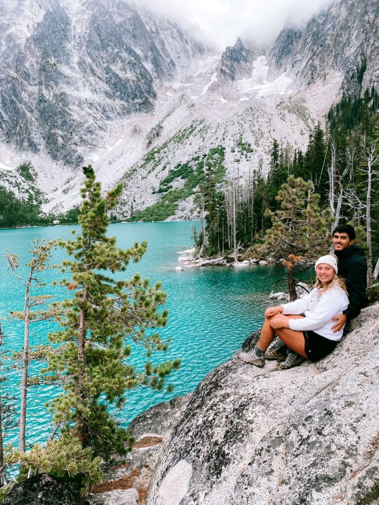 Posing in front of the blue waters of the lake