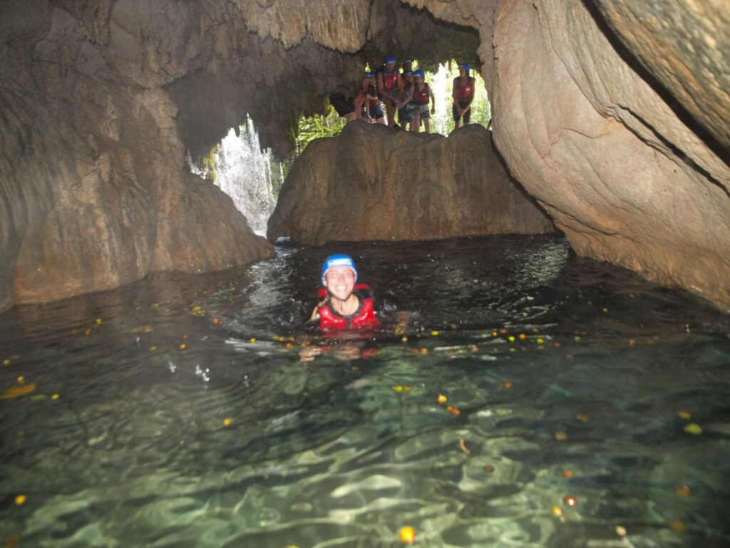 Swimming through a limestone cavern with Rafting Pirate Omis