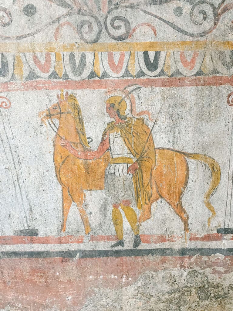 A fresco of a roman soldier with a golden horse.