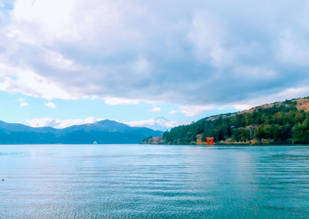The red torii of Hakone Shrine, Lake Ashi, and Mt Fuji in the distance.