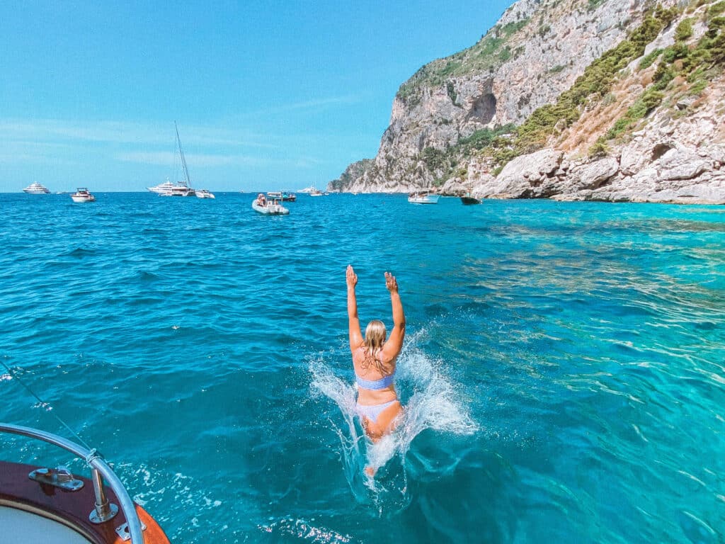 Jumping in to the water during the swimming period on our Capri private boat tour