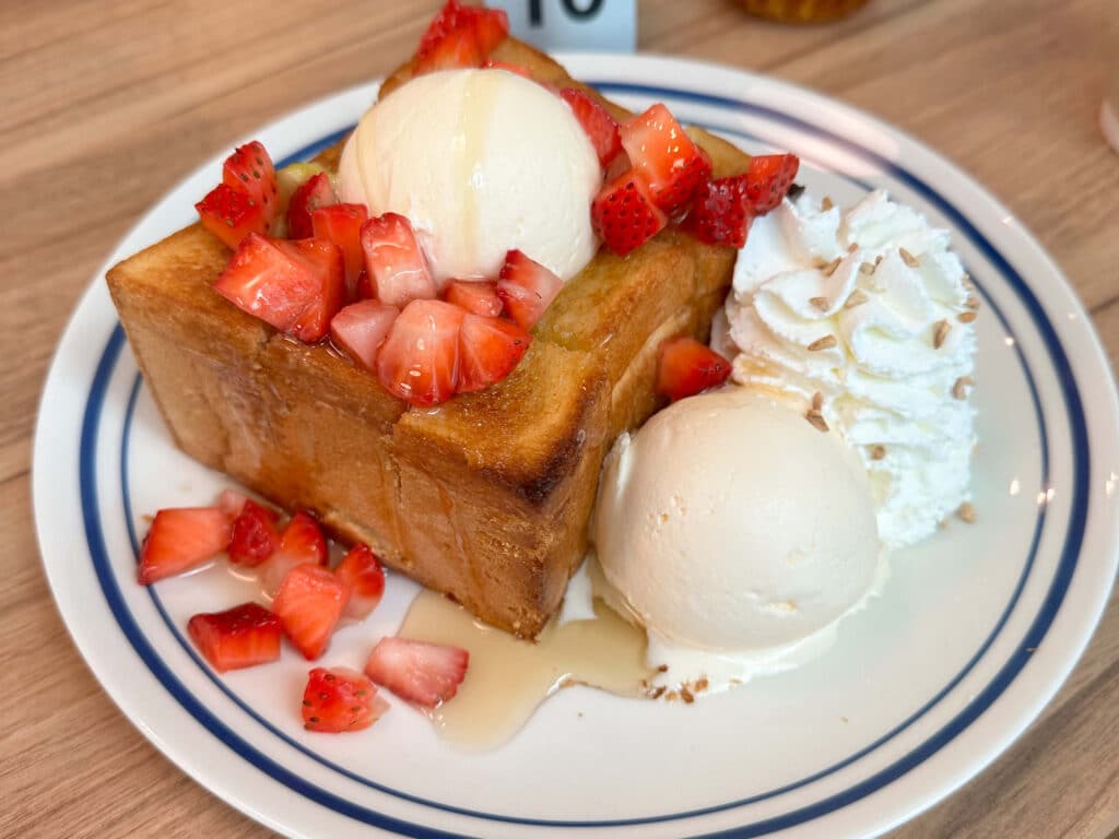 Dessert of golden toast with fresh strawberries, ice cream, and whipped cream at the After You Dessert Café near Eastin Grand Hotel Phayathai