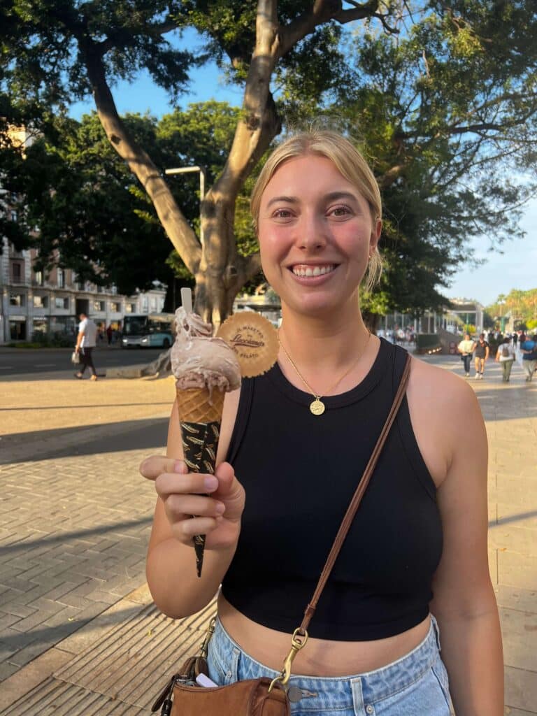 A woman holding a cone with two scoops of gelato from Luccianos in Malaga