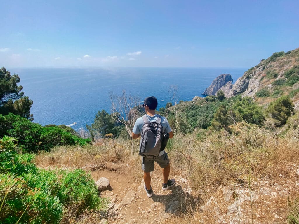 Hiker walking along a dry, exposed trail Little trail with a beautiful view
