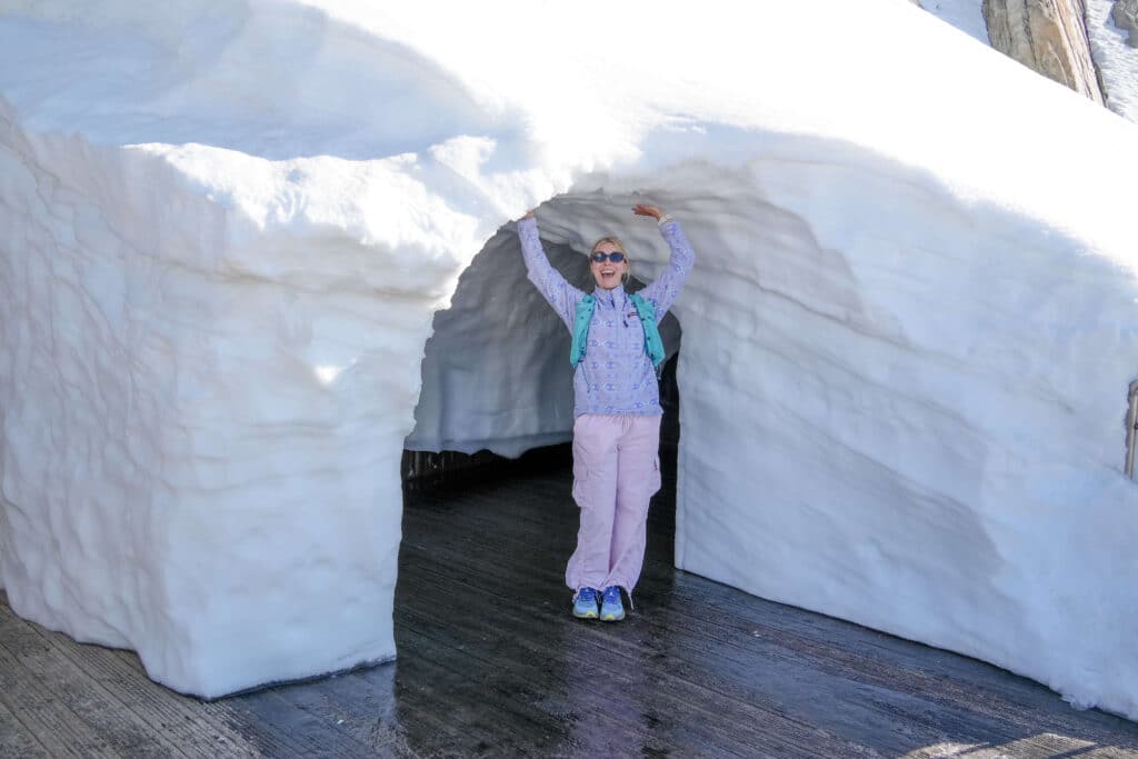 Traveler walking between snow walls near Aiguille du Midi station