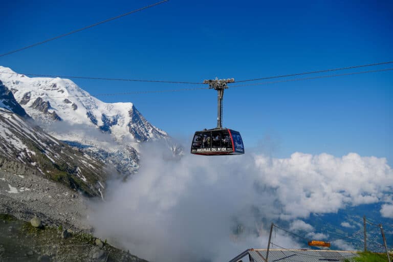 Aiguille du Midi cable car rising through the clouds with Mont Blanc in the background, accessed using the Mont Blanc MultiPass