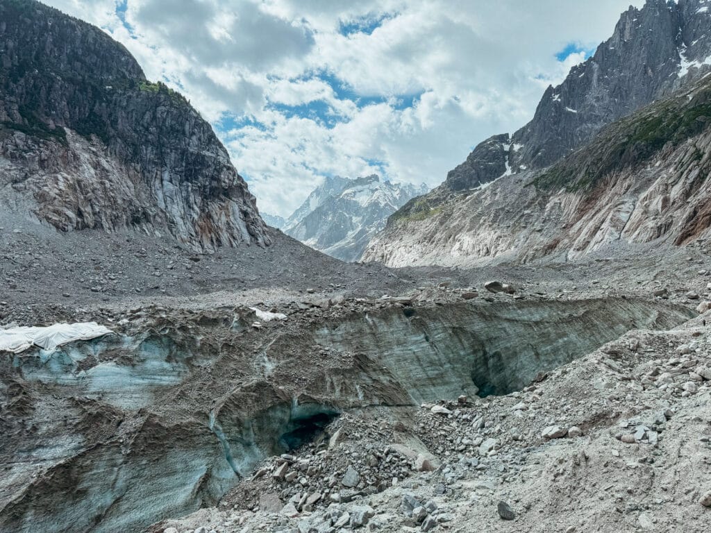 Close-up of the glacial moraine and meltwater pools near the Mer de Glace ice cave entrance.