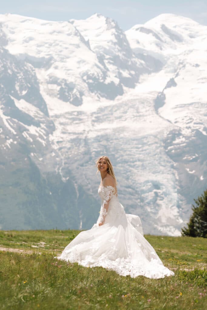 Bride standing solo in her gown facing the mountains in a moment of quiet reflection. Photo credit: Mathilde Rietsch.