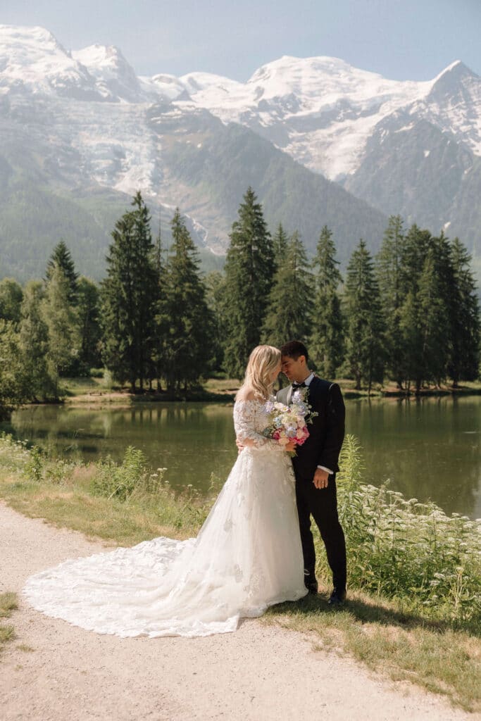 Bride and groom in a meadow near Les Gaillands with sweeping Alpine views. Photo credit: Mathilde Rietsch