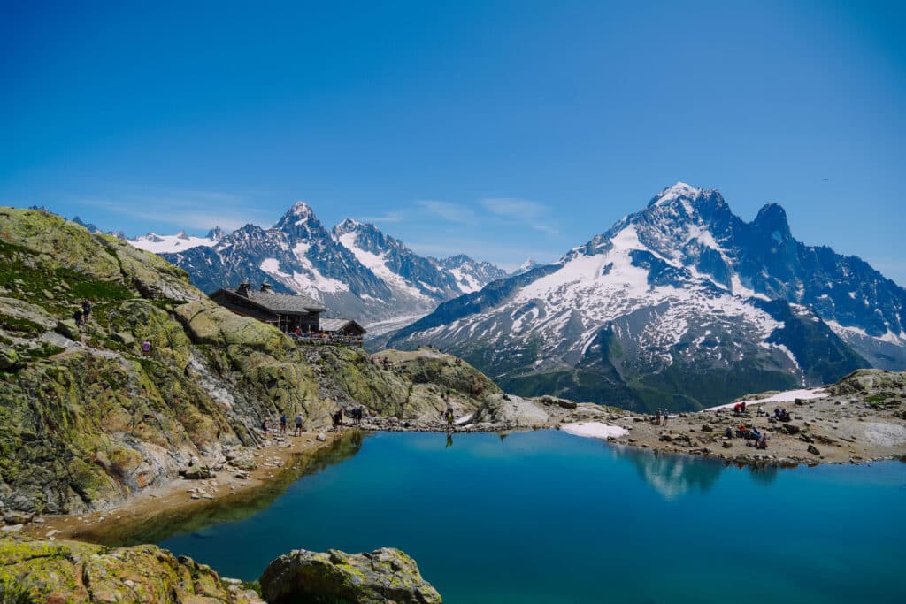 Crystal-clear Lac Blanc surrounded by rocky cliffs and mountain peaks