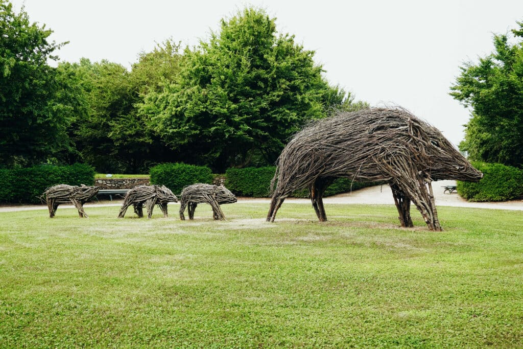 Sculptural topiary of grazing animals on the palace lawn near the orchard garden