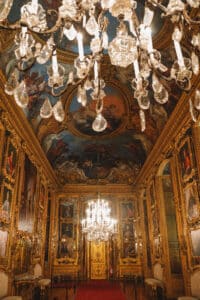 The gallery of Daniel, a Baroque reception room with mirrored walls, crystal chandeliers, and ceiling frescoes in the Royal Palace of Turin.