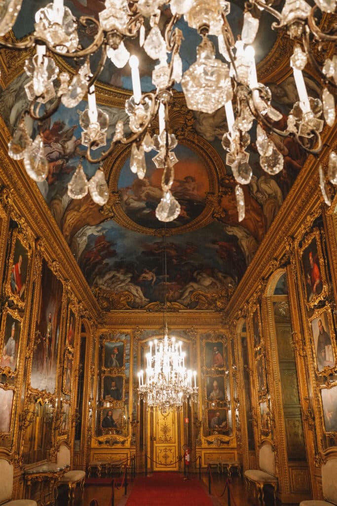 The gallery of Daniel, a Baroque reception room with mirrored walls, crystal chandeliers, and ceiling frescoes in the Royal Palace of Turin.