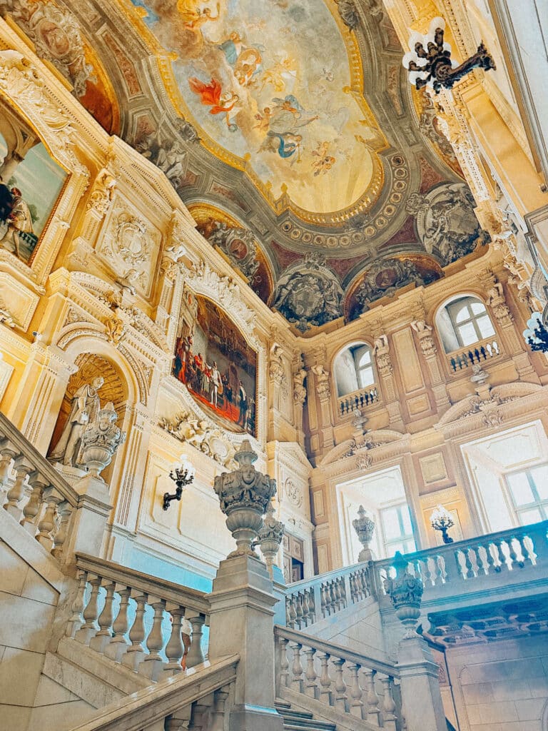 Baroque staircase and ornate frescoed ceiling inside the Royal Palace of Turin