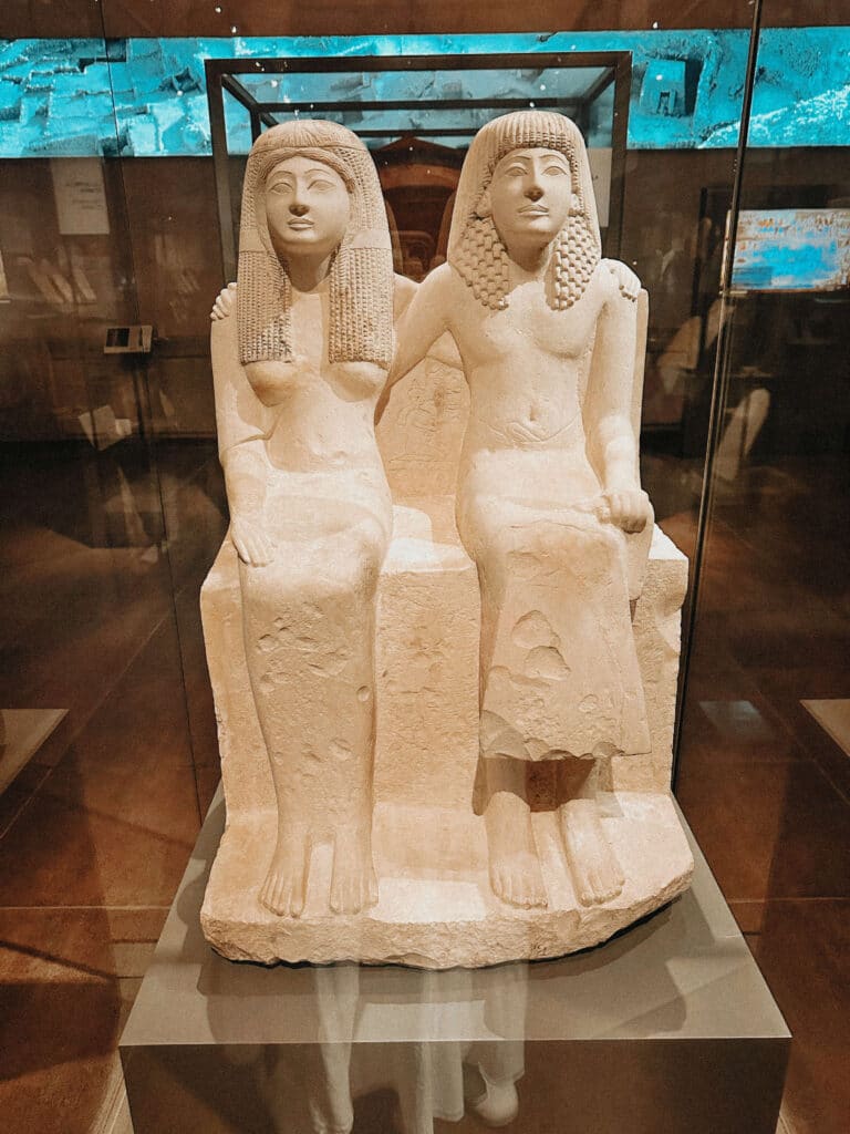 Ancient Egyptian statue of two seated figures at the Egyptian Museum in Turin