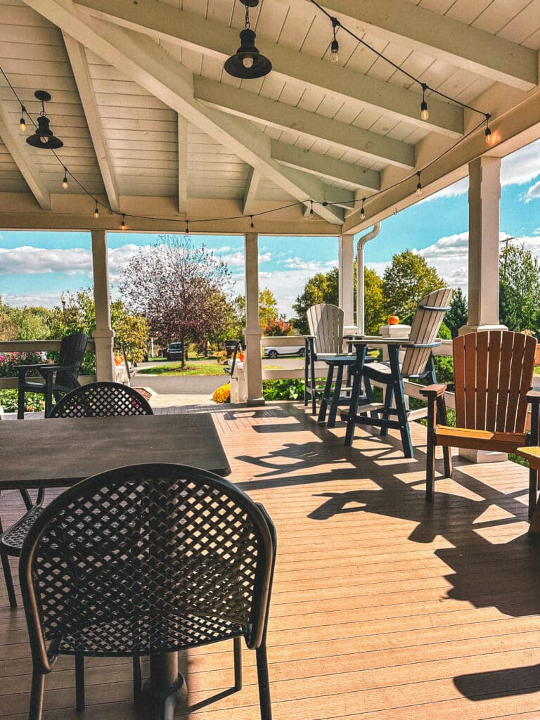 A large wrap around deck with outdoor seating at september farm cheese shop