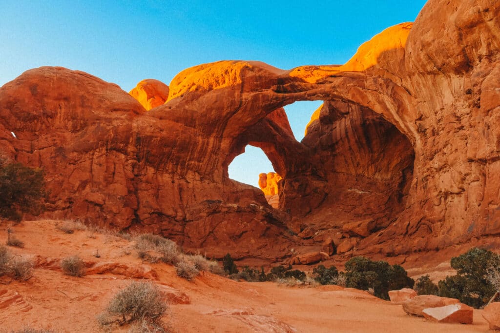 Double Arch seen from below with clear sky above from Arches National Park in December