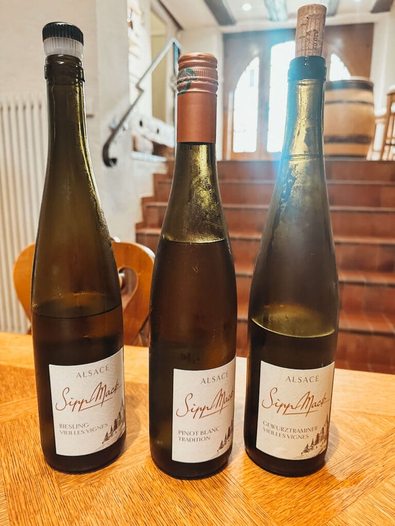 Close-up of three Gewürztraminer bottles from Alsace winery Sipp Mack