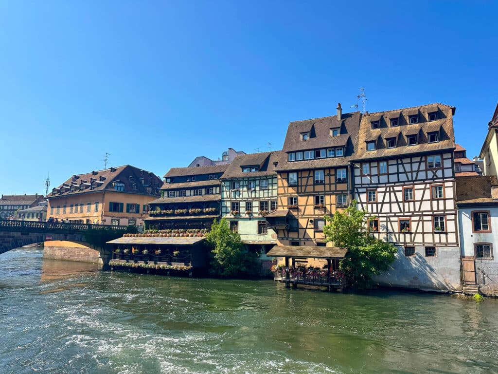 Canal-side restaurants and traditional Alsace-style buildings in Strasbourg’s Petite France quarter.