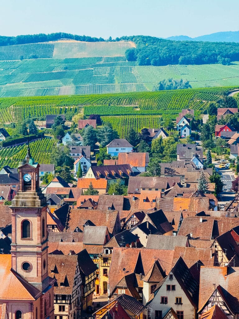 Rooftop view over the colorful houses and church steeples of Riquewihr, Alsace
