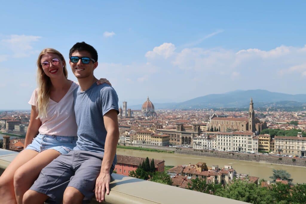 Two travelers smiling at the Vista Panoramica di Firenze in florence