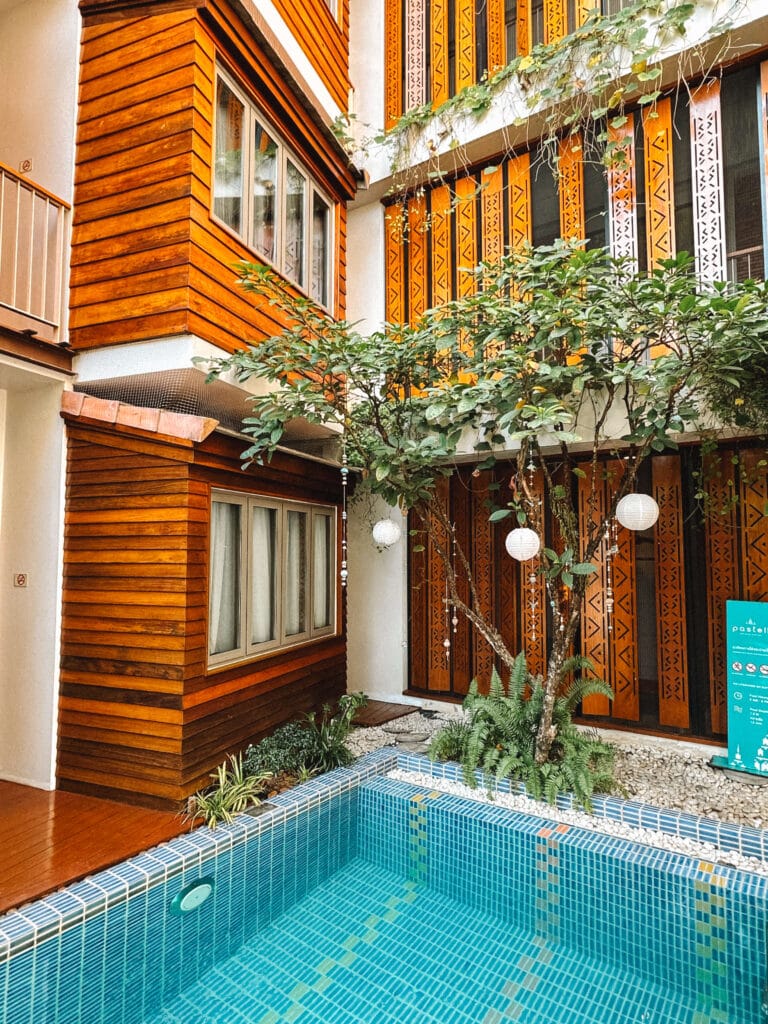 Small saltwater pool framed by greenery and boutique hotel balconies at Pastell Oldtown Chiang Mai.