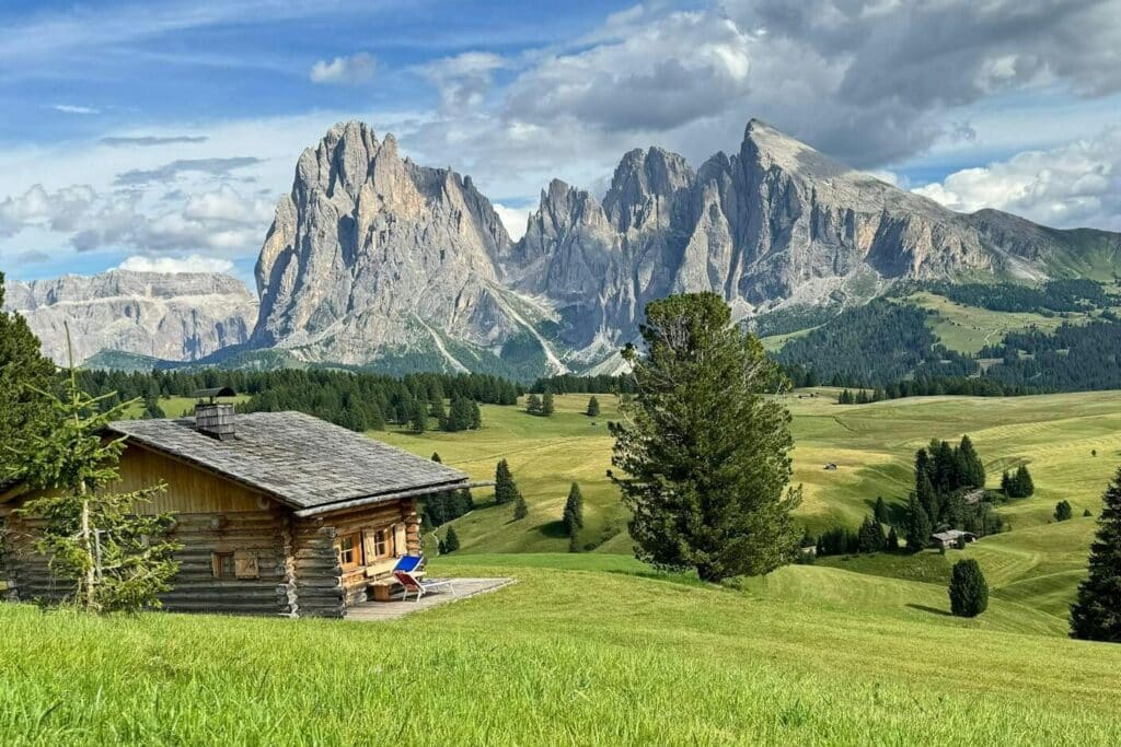 Rustic cabin in vibrant alpine landscape with scenic mountain view