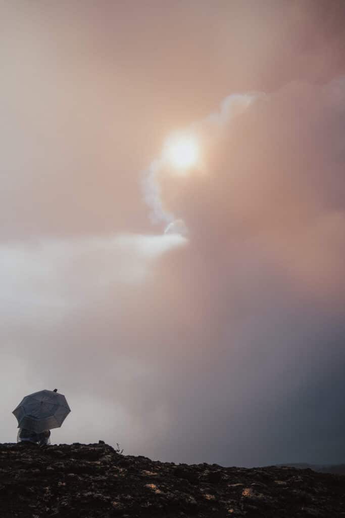 hick volcanic fog (vog) drifting through the crater, illuminated by a soft sunset glow.