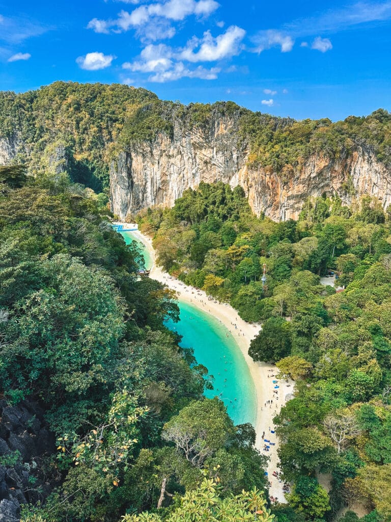 A turquoise lagoon encircled by limestone cliffs and dense greenery at Hong Island, viewed from above.