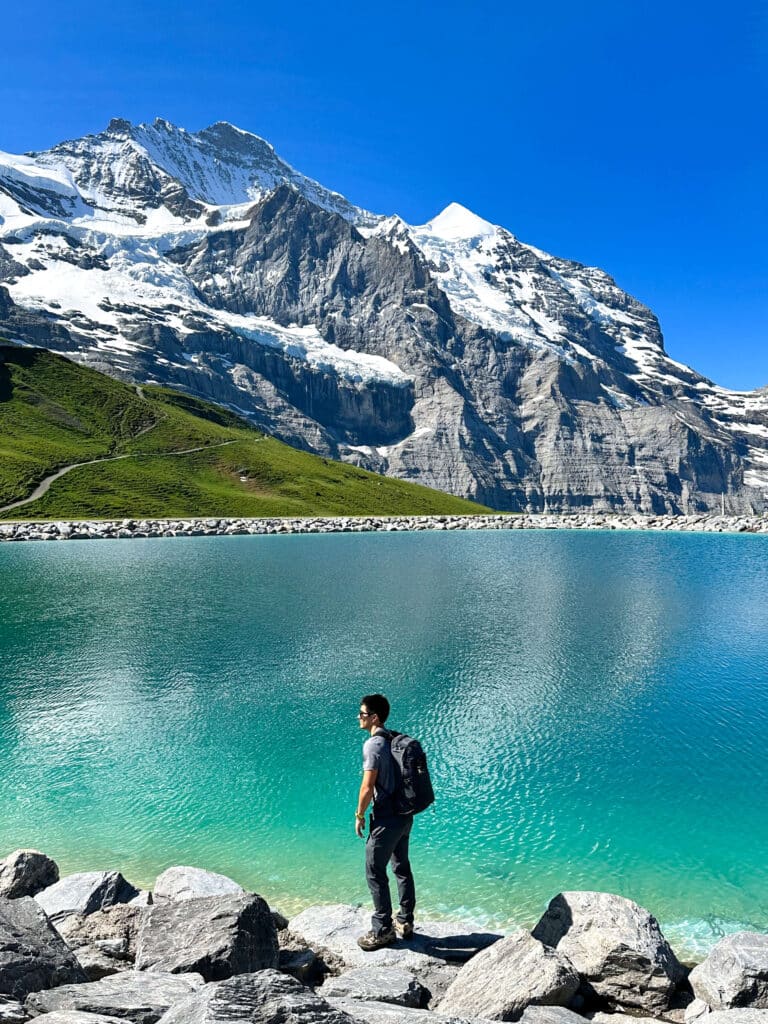 Clear blue water of Fallbodensee Lake beneath the dramatic North Face of the Eiger