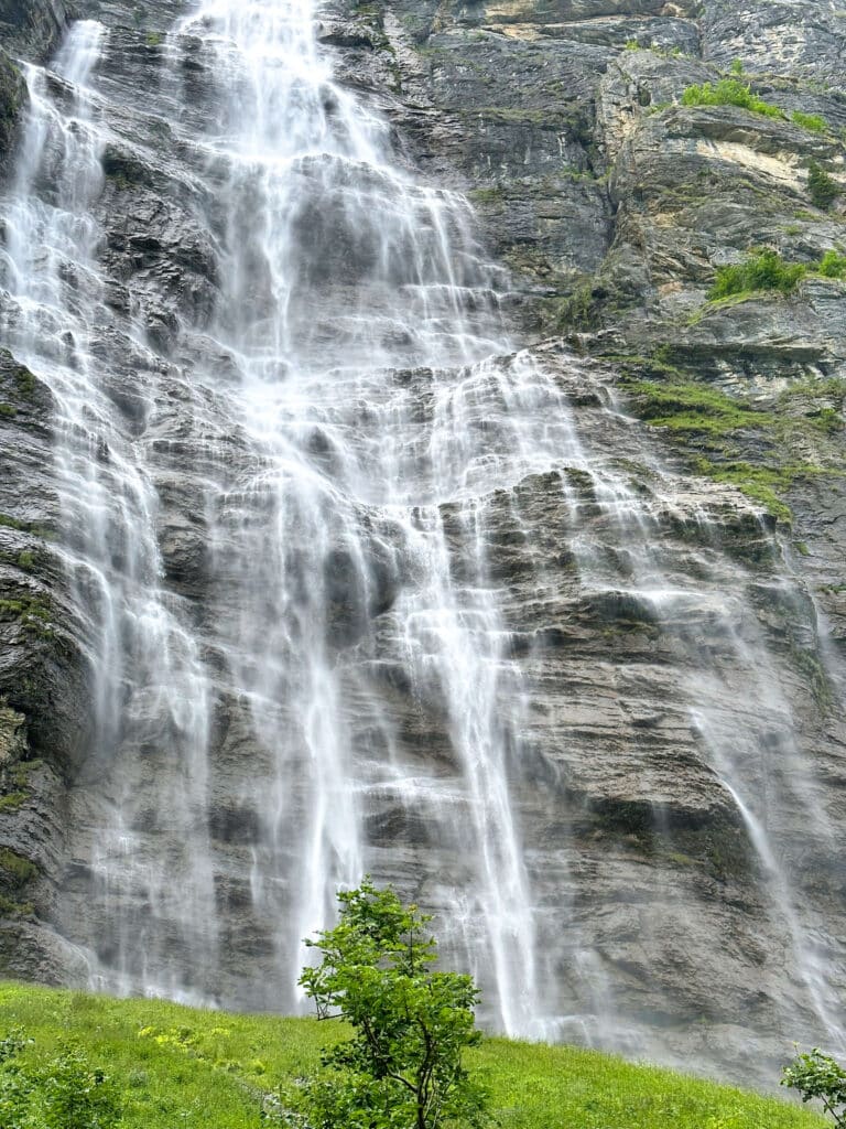 Mürrenbach Falls cascading down the cliffside above the Lauterbrunnen Valley floor