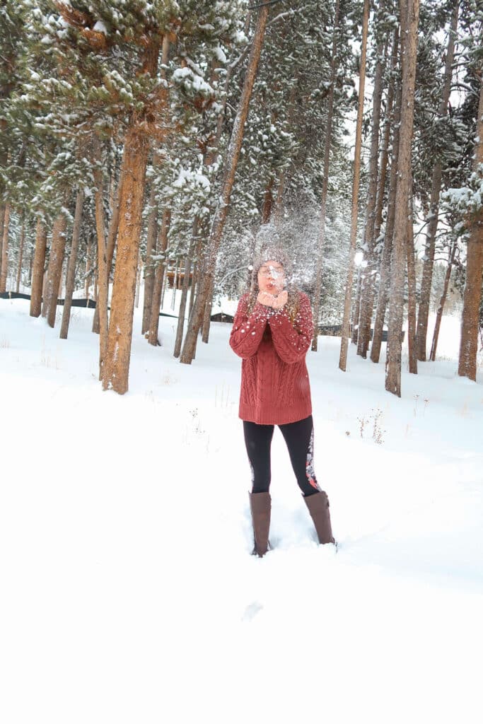 Red-jacketed figure standing in heavy blowing snow, mid-whiteout in Breckenridge.