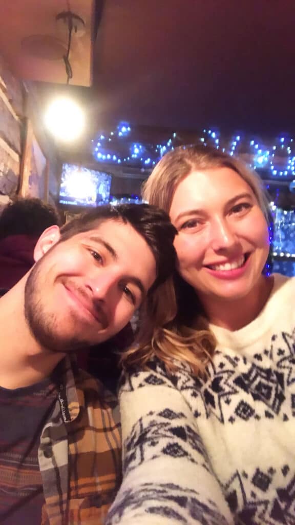 Friends smiling at an Irish bar in Breckenridge during a festive winter night out.