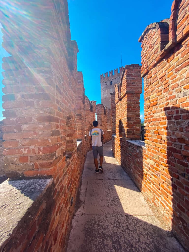 A visitor walking along the high ramparts of the Castelvecchio museum in Verona