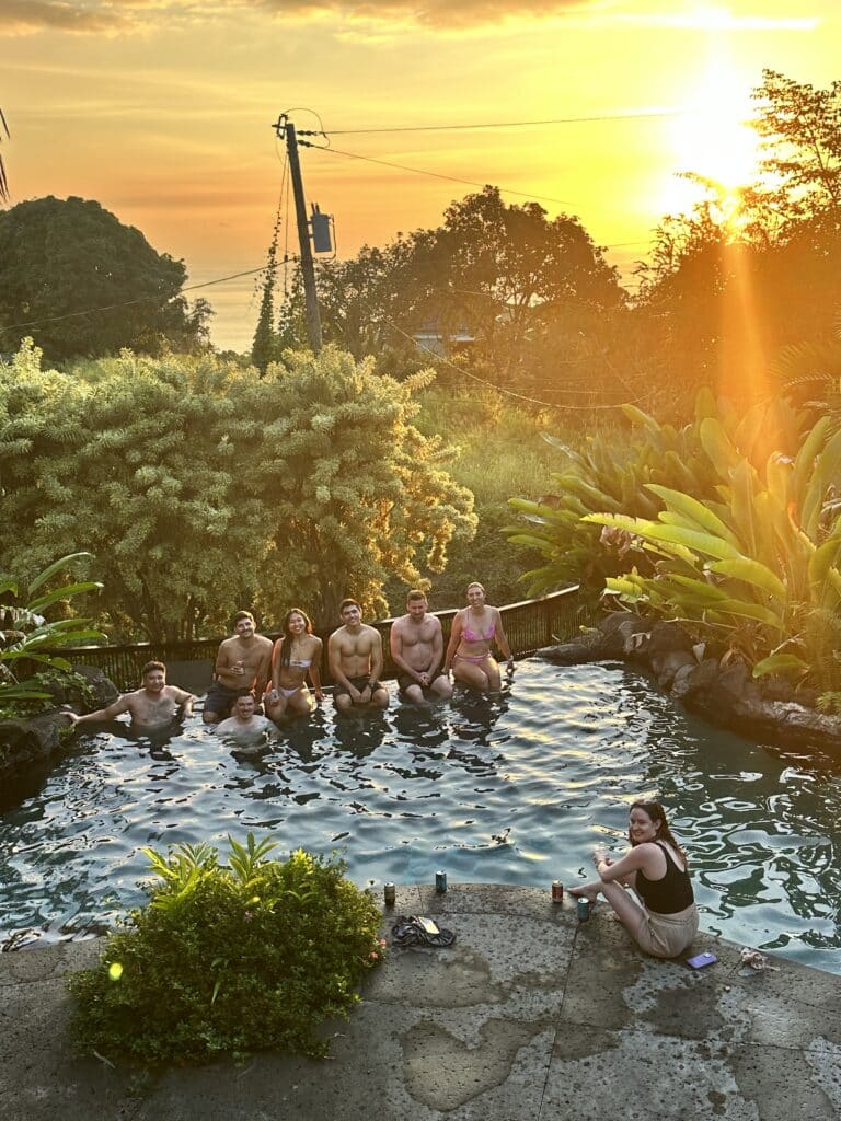 Friends sitting on the ledge of a pool