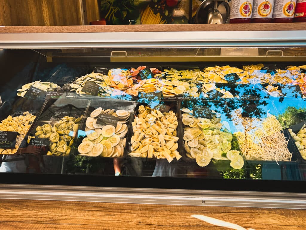 Fresh pasta selection in a market display case, Pernes-les-Fontaines Saturday market.