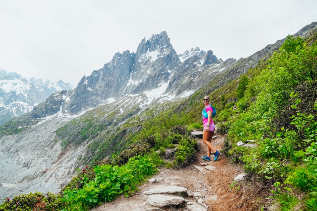 A happy hiker in a pink top and a blue trail running vest on the Signal Forbes trail just a short ways from the Montevers Station