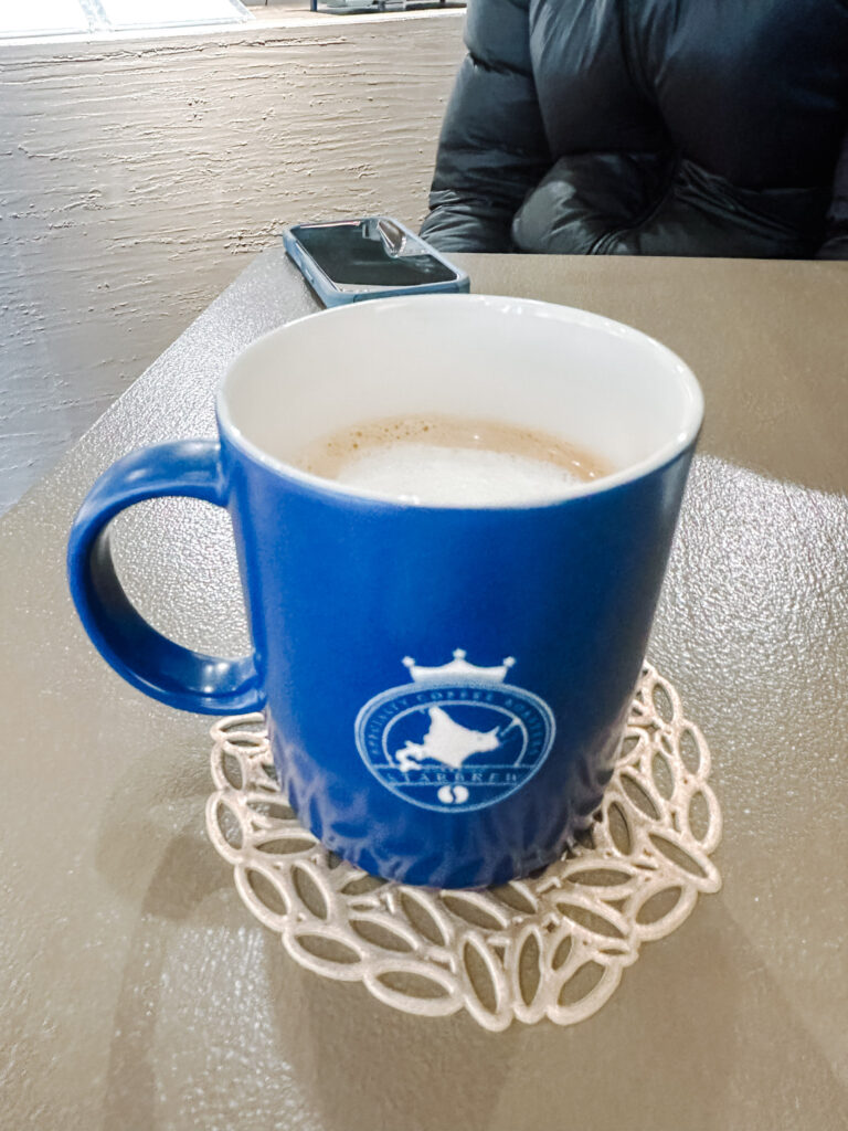Latte served in a blue mug on a coaster at HOKKAIDO STARBREW Sapporo specialty coffee café.