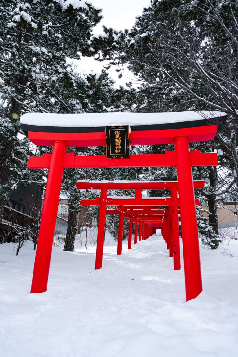 line of vivid red torii gates at Sapporo Fushimi Inari Shrine.