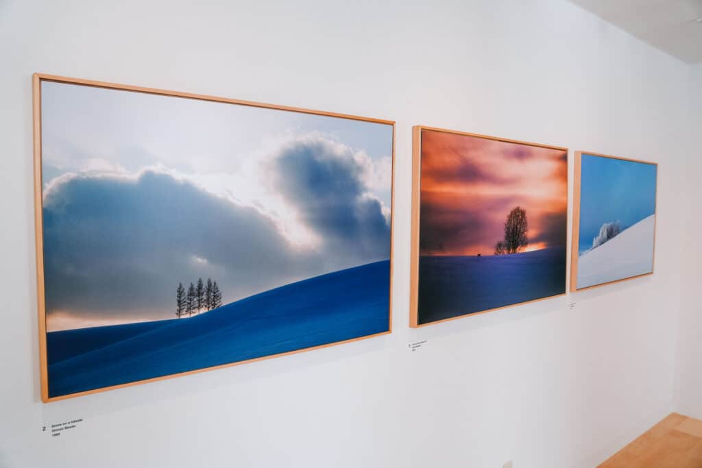 Interior of Takushinkan gallery showing Shinzo Maeda landscape photography of Biei, Hokkaido
