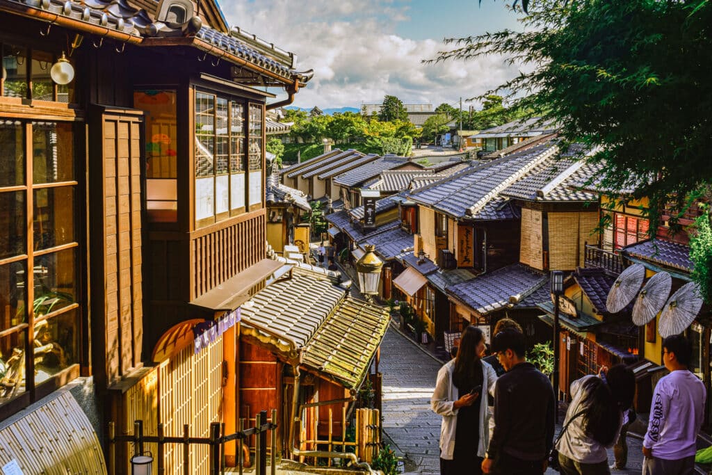 Tourists standing around in the narrow historic streets of the Kyoto old city