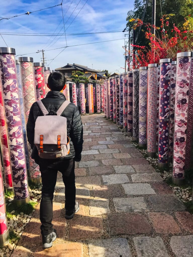 Brightly colored pillars decorated with used kimono fabrics at the kimono forest in Arashiyama