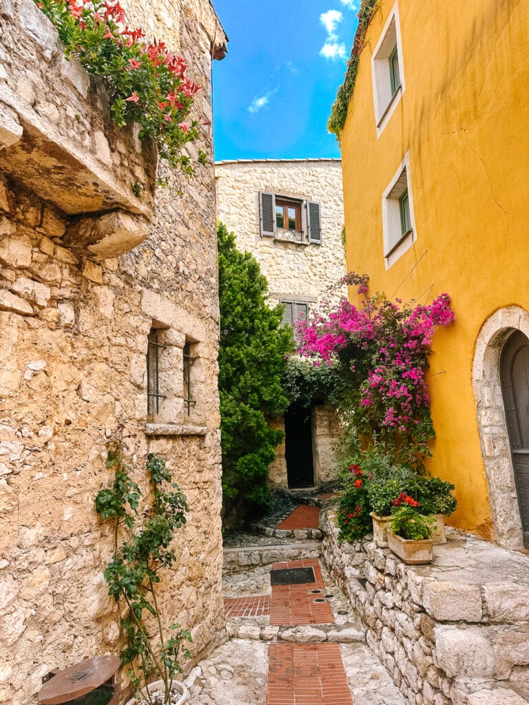 A narrow, cobblestoned alleyway in the hilltop village of Eze